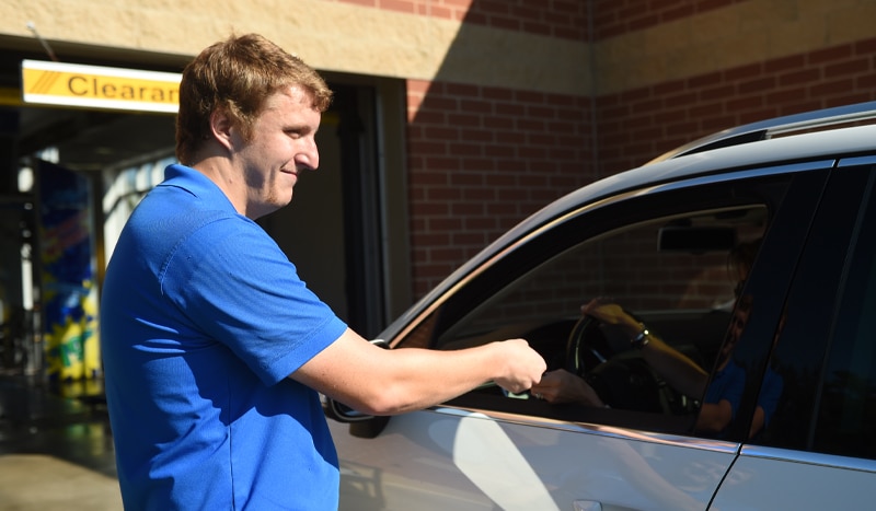 a man standing in front of a car