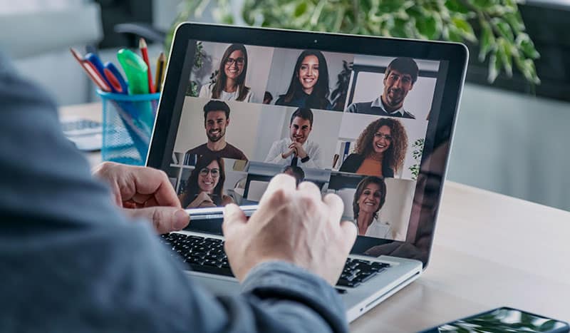 a group of people looking at a laptop screen